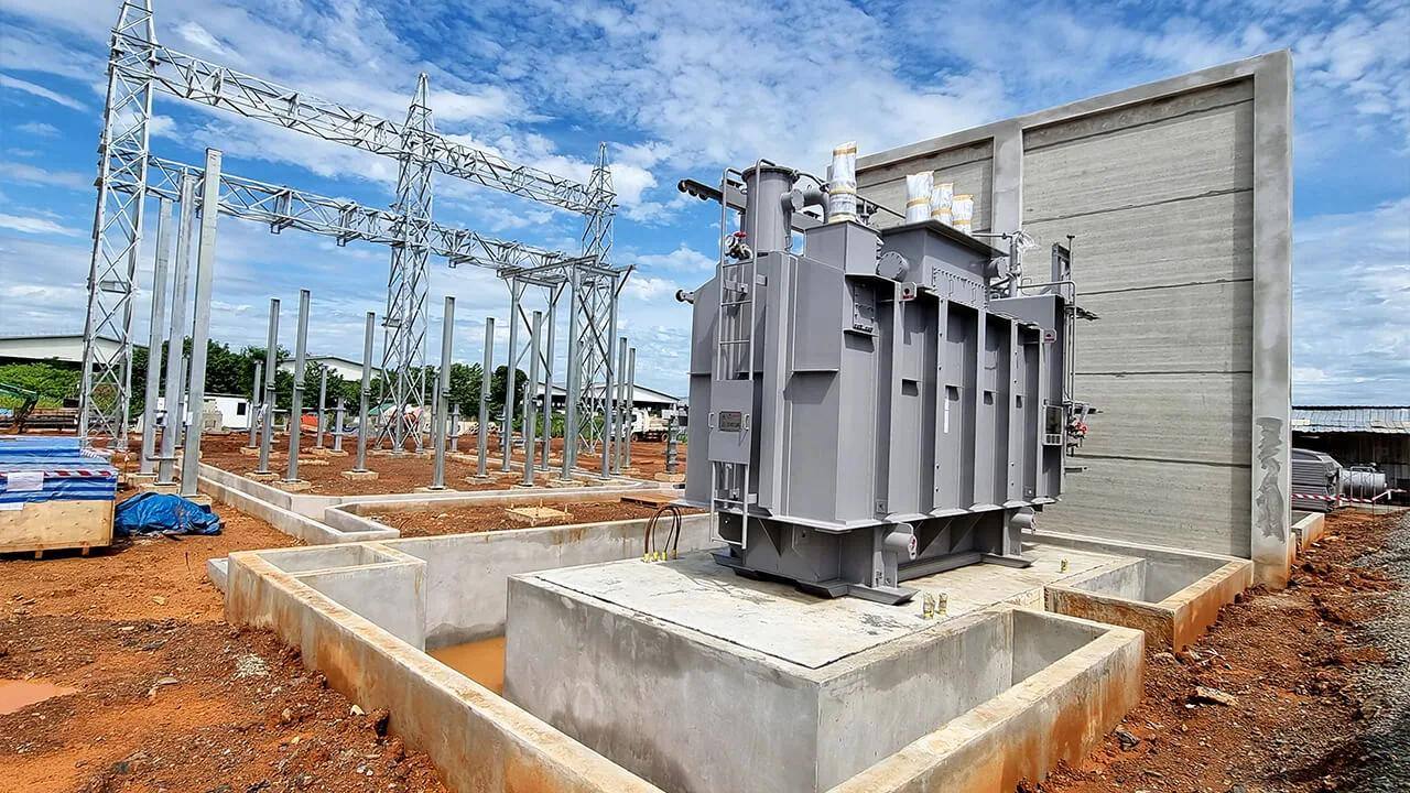 Main transformer positioned on its concrete plinth at an outdoor substation under construction